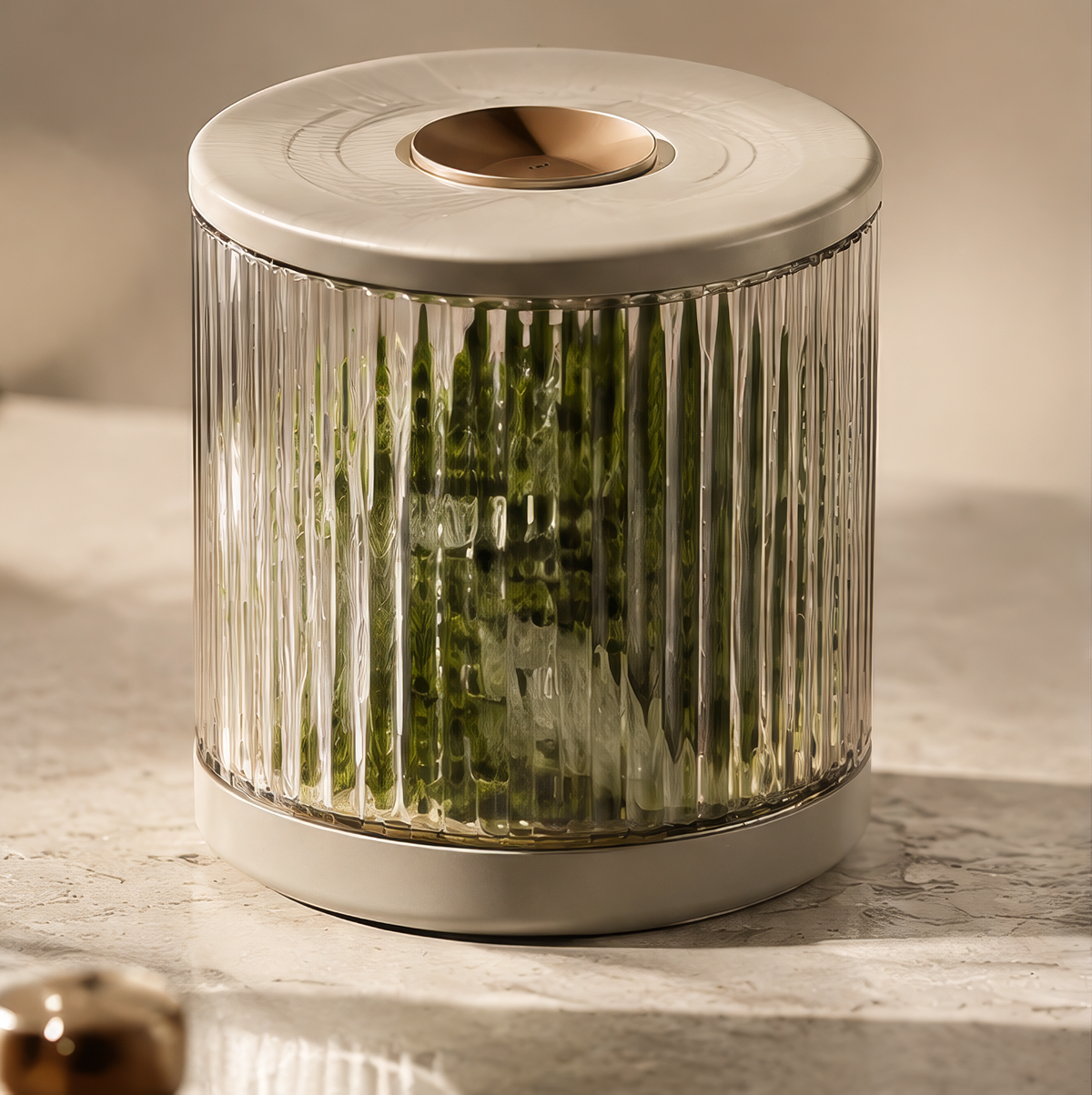 Clear ribbed cylindrical food storage jar with cream-coloured lid and base, filled with leafy greens