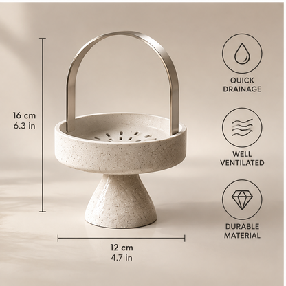 Round pedestal sponge holder displayed beside a kitchen sink