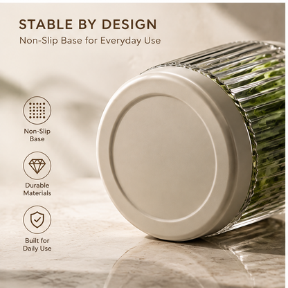 Top view of round cream-coloured lid with metallic-tone centre accent